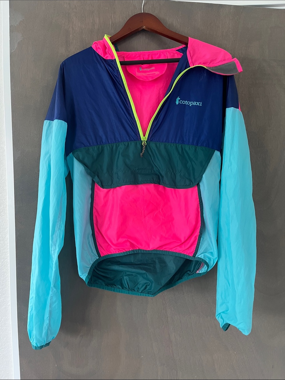 Cotopaxi Woman’s Bright Colorblock Windbreaker Jacket with front pocket and hood